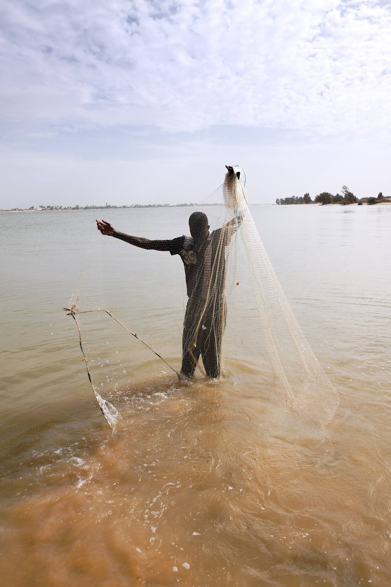 A fisherman casting a net